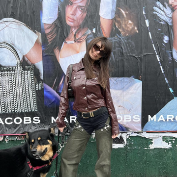Emily Ratajkowski Poses in Front of a Poster of Herself While Wearing Denim Chaps