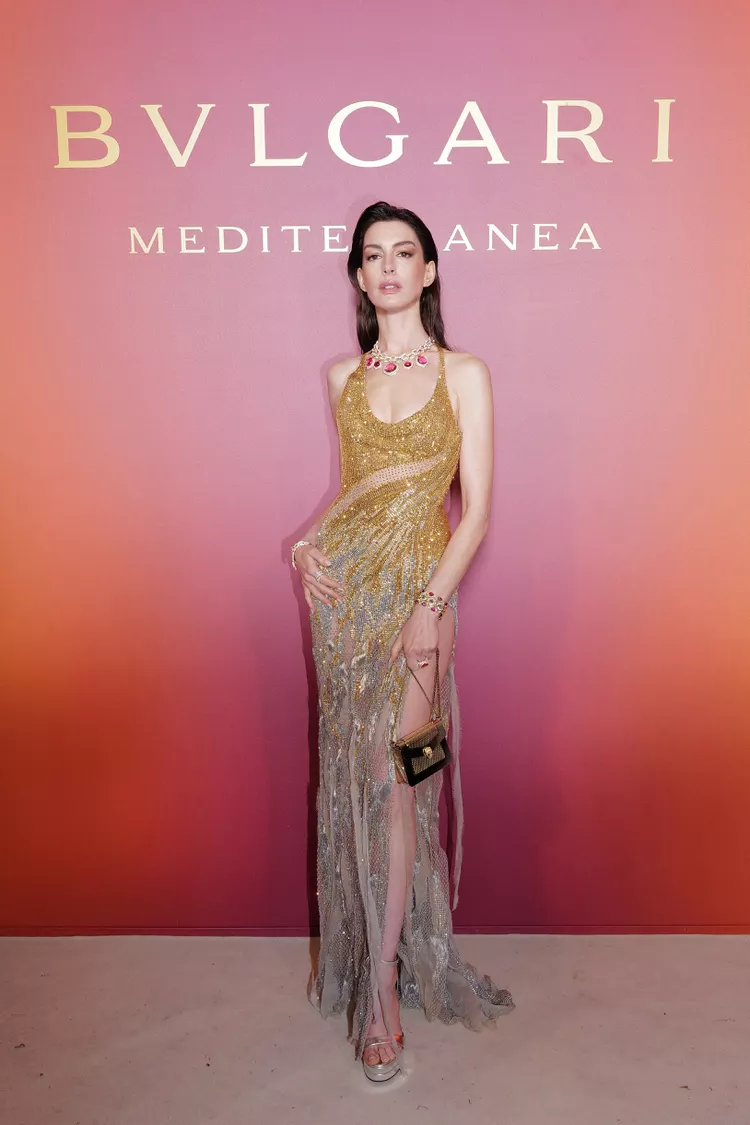 Anne Hathaway’s Glittery Gold Gown Came With a Sky-High Leg Slit and an Attached Hood