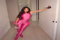 Kim Kardashian Took a Style Cue from the ‘Power Rangers’ in a Metallic Hot Pink Catsuit and Hip-High Boots