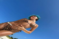 Hailey Bieber Paired the Tiniest Leopard String Bikini With a Turquoise Blue Bucket Hat